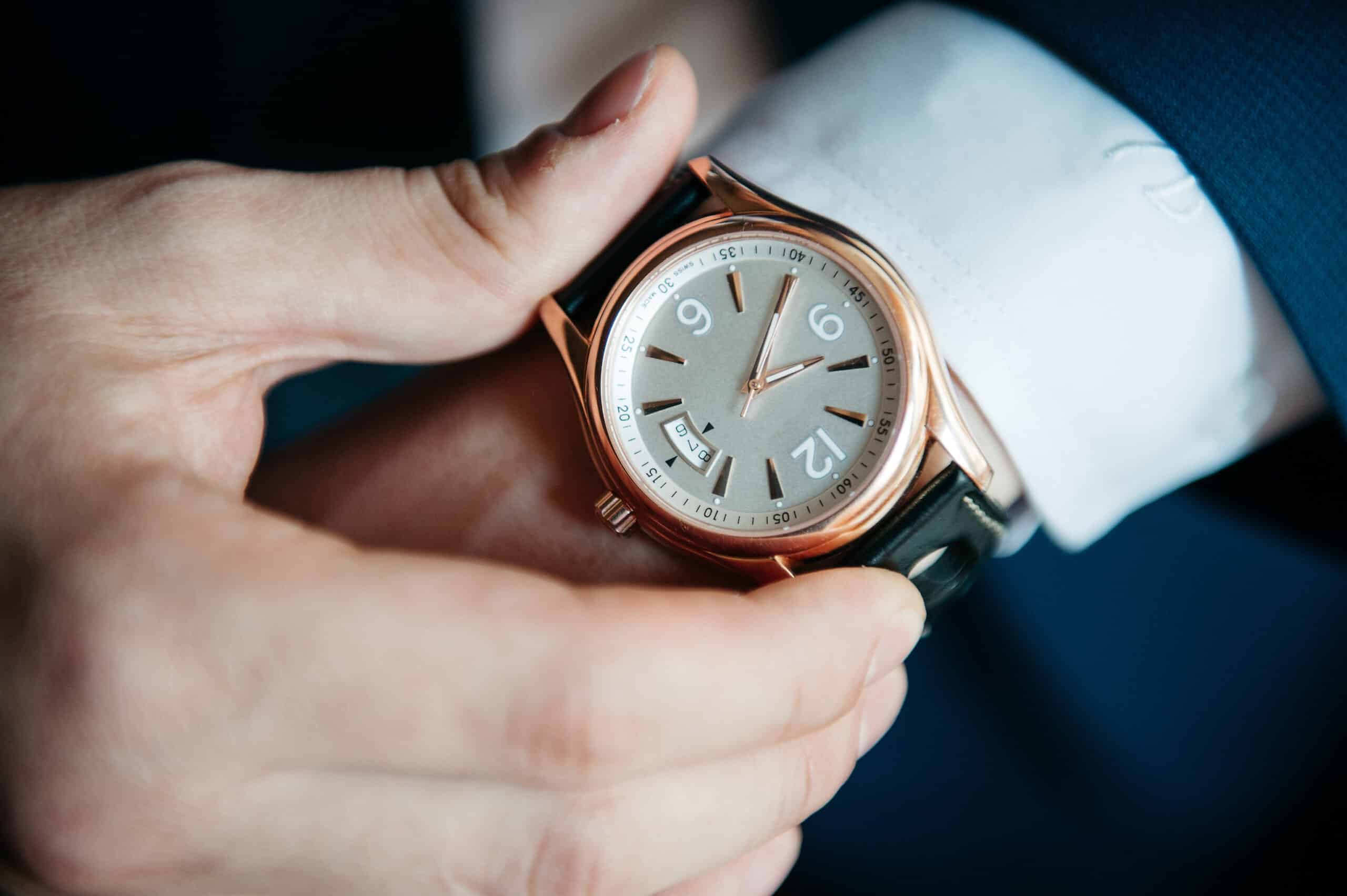 businessman looking at his watch on his hand, watching the time